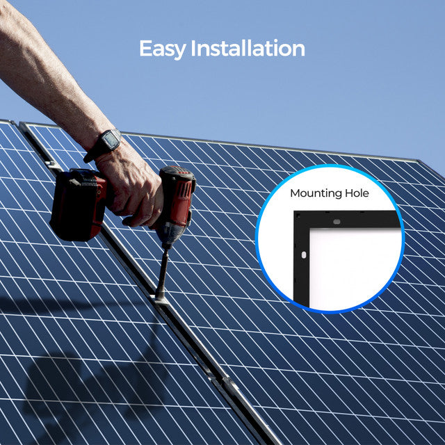 Person using a drill to install solar panels with a clear blue sky background